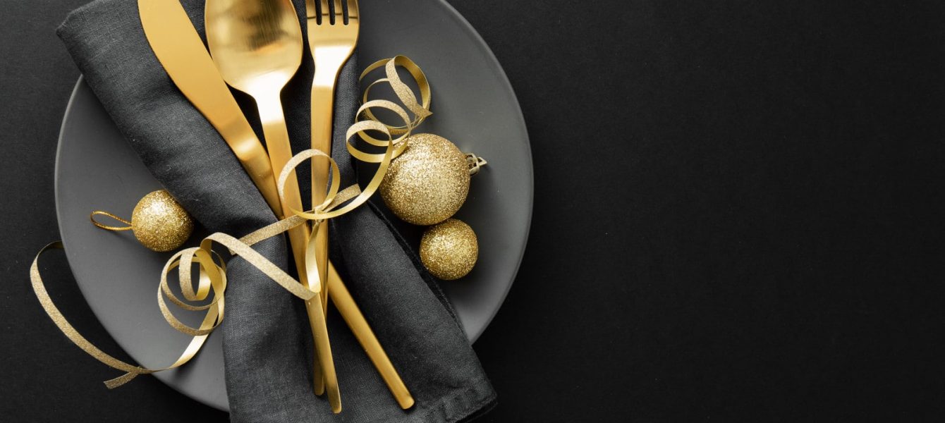 Gold cutlery served on plate for Christmas Dinner