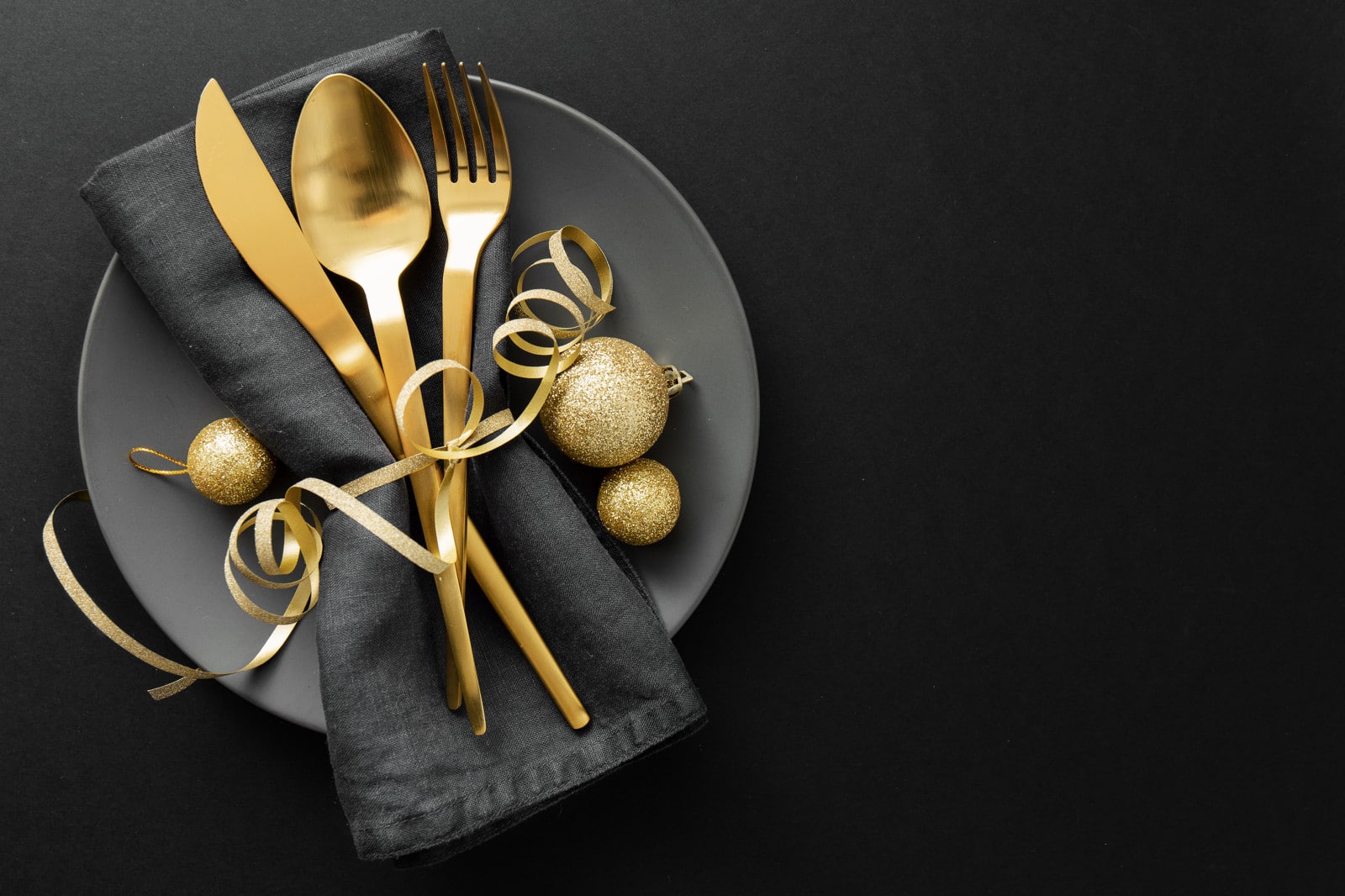 Gold cutlery served on plate for Christmas Dinner